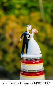 Bride And Groom Cake Topper Isolated On Yummy Wedding Cake