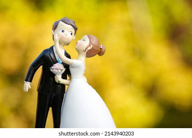 Bride And Groom Cake Topper Isolated On Yummy Wedding Cake