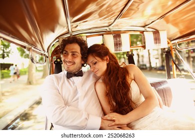 Bride and groom in a car in Paris, France