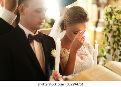 Bride And Groom In The Church During The Christian Wedding Ceremony.