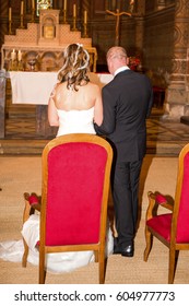 Bride And Groom At Church Wedding Alter Ceremony On The Chairs
