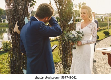 Bride And Groom Cry Standing Before Wedding Altar In The Rays Of Evening Light