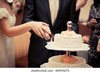 The Bride And Groom Cut The Wedding Cake