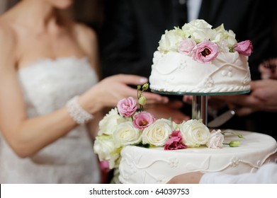Невеста и жених разрезают свой свадебный торт