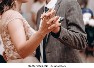 bride and groom dancing at wedding ceremony, close-up view of hands - Powered by Shutterstock