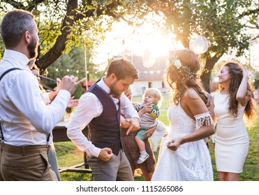 Bride And Groom Dancing At Wedding Reception Outside In The Backyard.