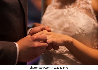 the bride and groom exchange rings. High quality photo - Shutterstock ID 1929414473