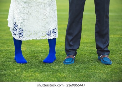 Bride And Groom Feet On The Football Field Grass Close Up.