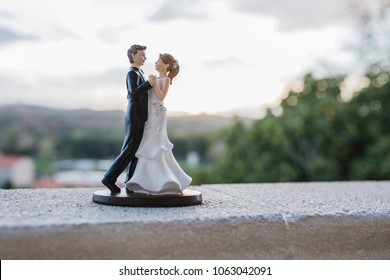 bride and groom figurines on the wedding cake - Powered by Shutterstock