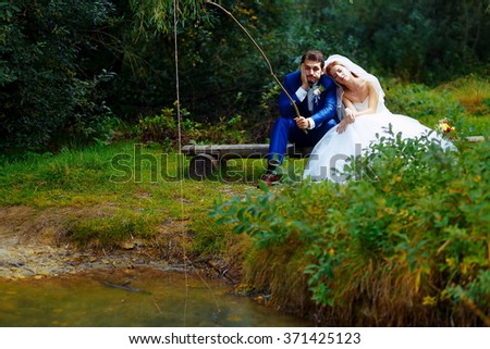 bride and groom fishing together - romantic wedding concept
