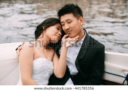 Bride and groom are floating on a boat on the city's rivers and canals
