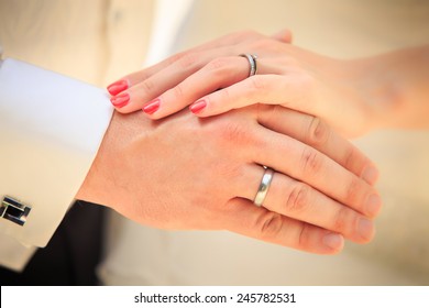 bride and groom hands with golden rings clouseup