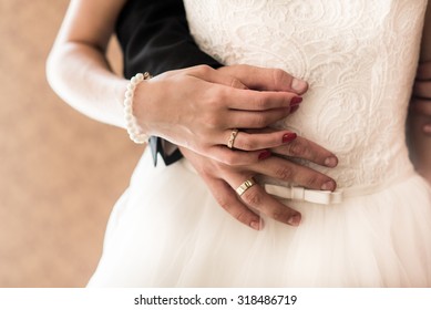 The Bride And Groom Held Hands And Show Wedding Ring