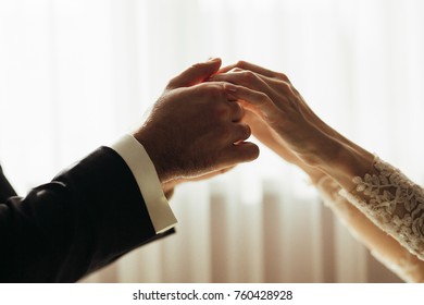 Bride and groom hold each other hands together tender - Shutterstock ID 760428928