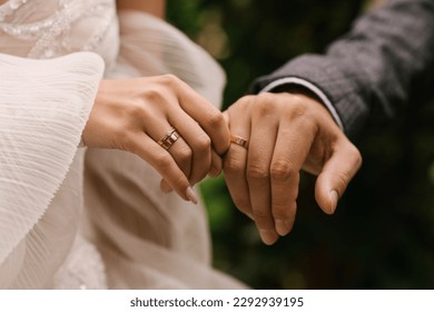 The bride and groom hold hands - Shutterstock ID 2292939195