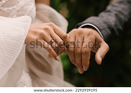 The bride and groom hold hands