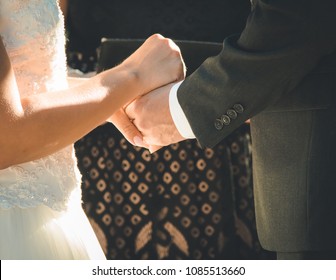 Bride And Groom Holding Hands At Alter