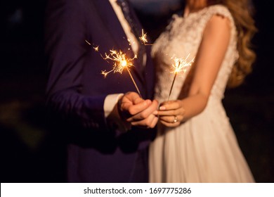 Bride And Groom Holding Wedding Sparklers