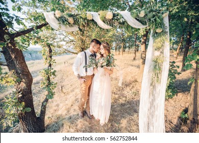 Bride And Groom Hugging At The Wedding In Nature.