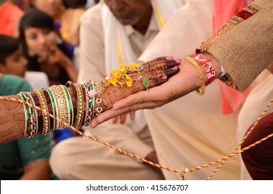 bride and groom joining hands during an Indian  wedding ritual - Shutterstock ID 415676707