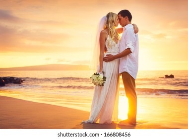 Bride and Groom, Kissing at Sunset on a Beautiful Tropical Beach, Romantic Married Couple