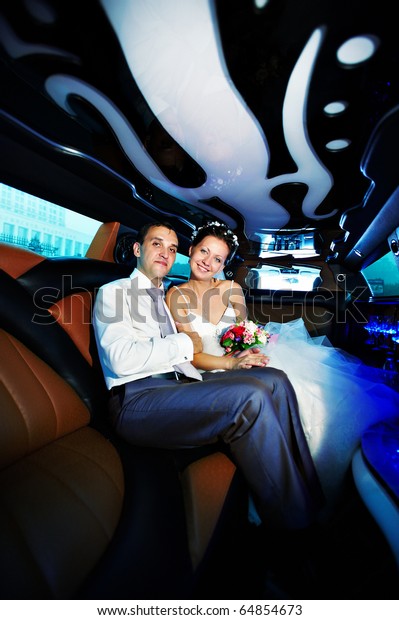 The bride
and groom in a luxury wedding
limousine