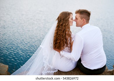 bride and Groom near Lake in wedding day