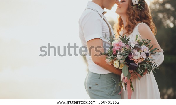the bride and groom on the background of a mountain stream