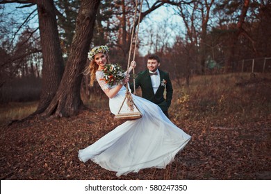  Bride And Groom On Swing On Rustic Autumn Wedding