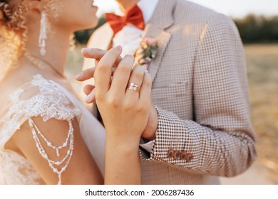 Bride And Groom On Wedding Day Hug And Show Love At Sunset