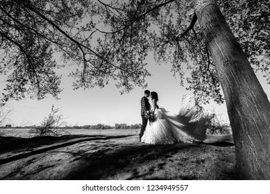 Bride and Groom posing in the forest