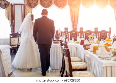 Bride and groom in restaurant. Wedding table at a wedding feast, dinner and party.