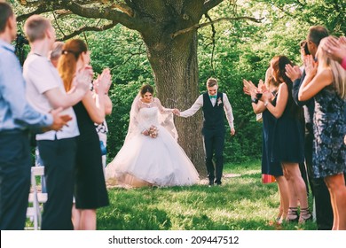 bride and groom running between guests lines