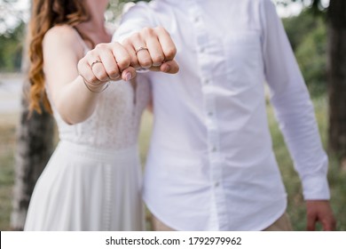 Bride And Groom Show Rings On Their Hands