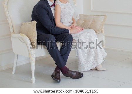 the bride and groom sit on the couch