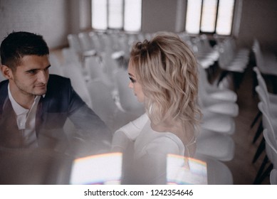 Bride and groom are sitting on chairs