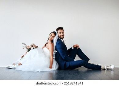 Bride, groom and smile mockup for marriage with flower bouquet, wedding and celebration together. Happy couple, unity and commitment for love, excited and portrait on floor and white wall background - Powered by Shutterstock