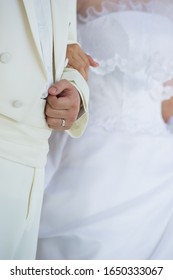 Bride And Groom Standing At The Alter Close Up On Hands No Faces