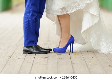 bride and groom standing on wooden bridge in park - Powered by Shutterstock