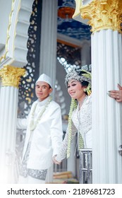 The Bride And Groom Wear Simple And Elegant White Javanese Traditional Clothes, Indonesia August 3, 2022