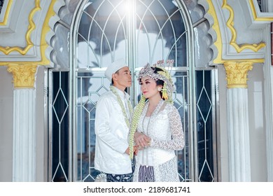 The Bride And Groom Wear Simple And Elegant White Javanese Traditional Clothes, Indonesia August 3, 2022