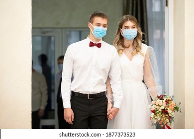 Bride and groom wearing medical masks. Getting married during the coronavirus pandemic. - Powered by Shutterstock