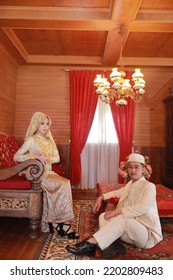 A Bride And Groom Wearing Traditional Minangkabau Clothing Pose For A Photo At A House Before A Wedding Reception In July 2022 In The City Of Bukittinggi, West Sumatra, Indonesia