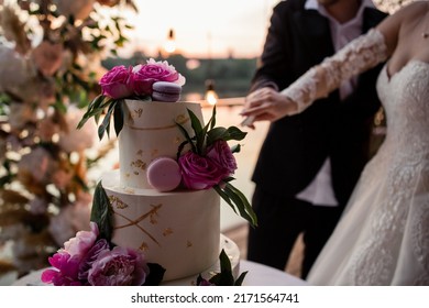 bride and groom at the wedding cutting the wedding cake - Shutterstock ID 2171564741