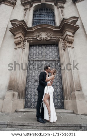 Bride and groom at wedding Day walking outdoors. Wedding fashion portrait of loving couple outdoor wide angle 