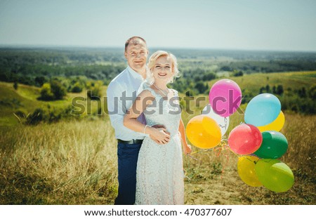 Bride and groom at wedding day, walking outdoor at summer on nature. Bridal couple, happy newlywed woman and man embracing. Loving wedding couple outdoor. 