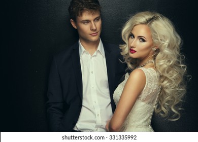 Bride and groom wedding photo taken in the studio on a black background  - Powered by Shutterstock