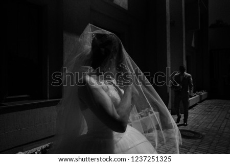 Bride and groom at the white wall