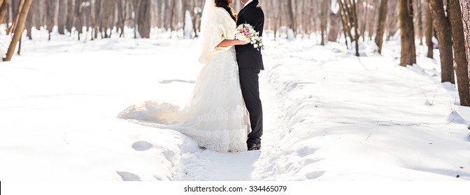 Bride And Groom In The Winter Forest