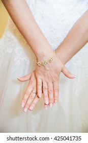 Bride hand on wedding dress with a nice manicure.